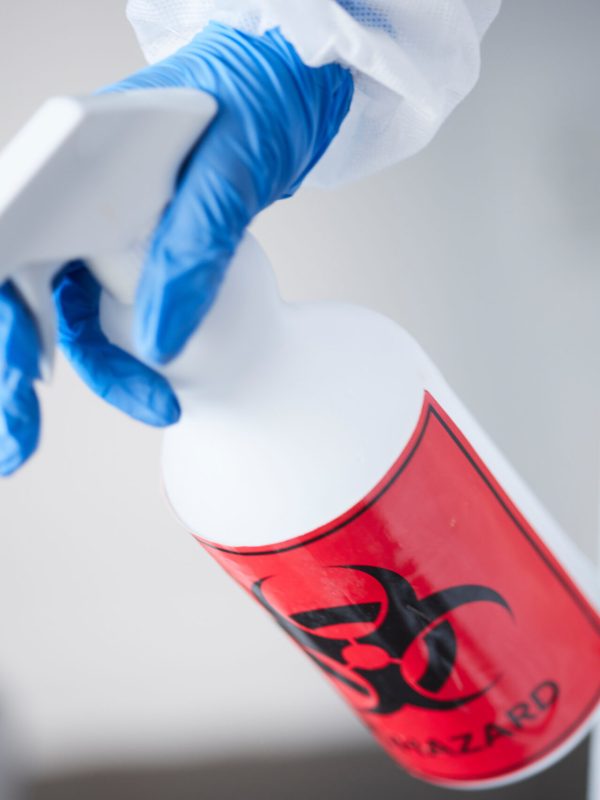 Hazmat suit, spray bottle and gloves for biohazard, covid and stop virus for safety, protection or .
